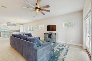 a living room with a couch and a ceiling fan at Stella Maris in Perdido Key