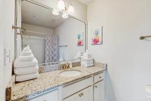 a bathroom with a sink and a mirror at Stella Maris in Perdido Key +15 photos