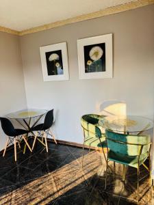 a dining room with two tables and two chairs at Indalo Guesthouse in Vryheid +15 photos