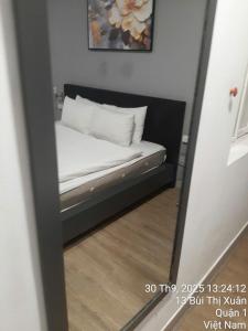 a reflection of a bed in a mirror at Khap Khap Thai Res Hotel 4 in Ho Chi Minh City