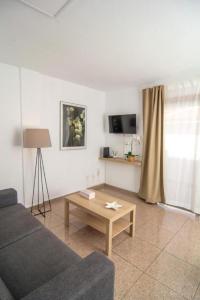 a living room with a couch and a coffee table at Le Petit Paradise in Playa de las Americas