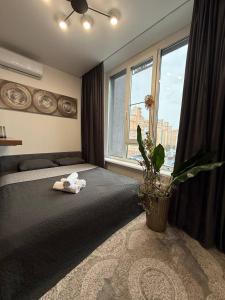 a bedroom with a bed with two towels on it at Апартамети люкс класу in Kyiv