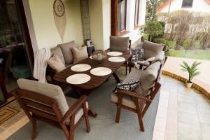 a wooden table and chairs in a living room at Willa na skraju lasu Fox - MAZURY in Kruklanki