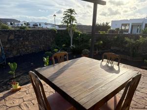 a wooden table and chairs on a patio at Loft Tortuga in Tinajo