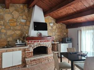 a living room with a stone wall with a fireplace at L'antico Orologio in Isola Capo Rizzuto
