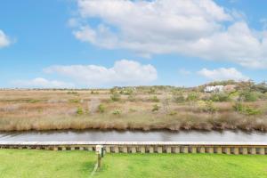 a bridge over a river in a field at SBC1001 - Sweet Retreat in Ice Plant Island +40 photos