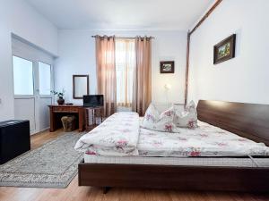a bedroom with a large bed and a window at Vila Brazilor in Căciulata