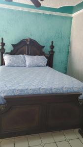 a bed with a wooden headboard in a bedroom at Seaview Luxury Retreats in Montego Bay +11 photos