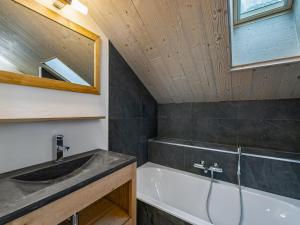 a bathroom with a sink and a bath tub at Chalet moderne avec parking et wifi, à proximité des pistes et commerces - FR-1-566-20 in Les Allues