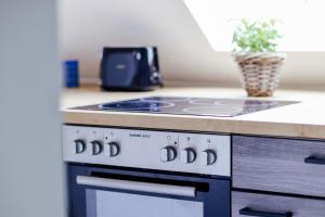 a stove top oven sitting in a kitchen next to a counter at Große City-Wohnung, salt apartments Weissenfels in Weißenfels