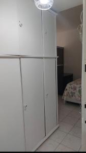 ein großer weißer Schrank in einem Zimmer mit einem Bett in der Unterkunft Andar Alto Frente Ipanema in Rio de Janeiro