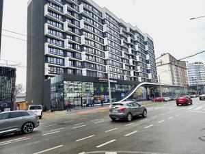 a busy city street with cars driving on the road at Belvedere Apart 2, parking in Ivano-Frankivsʼk