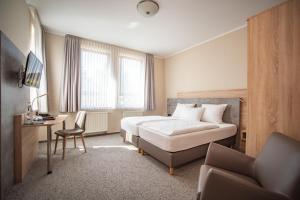 Postel nebo postele na pokoji v ubytování Hotel Hollmann + 25 fotografií