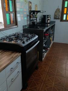 a kitchen with a stove top oven in a kitchen at Sítio entre amigos in Marechal Floriano