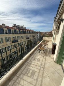 a balcony with tables and chairs on a building at Sweethome Massena in Nice