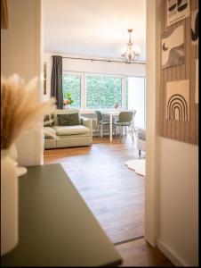 a living room with a couch and a table at Black Forrest Base Vauban in Freiburg im Breisgau