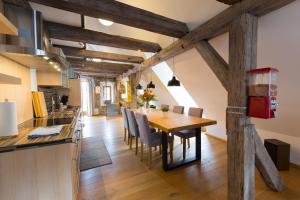 a kitchen and dining room with a wooden table and chairs at Ferienwohnung im Bortenmacherhaus in Neuburg an der Donau