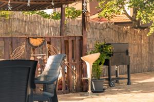 a patio with two chairs and a table and a fence at Indigo Villas in Pismenovo