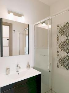 a bathroom with a sink and a shower at Sunny Beach Apartment - Big Terrace - Free WiFi in Calafell