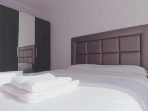 a bed with white sheets and white towels on it at Sunny Beach Apartment - Big Terrace - Free WiFi in Calafell