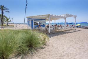 a gazebo on the beach next to the beach at Sunny Beach Apartment - Big Terrace - Free WiFi in Calafell