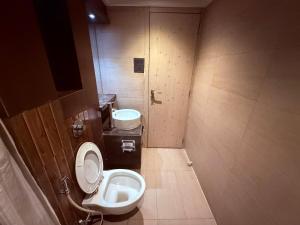 a bathroom with a toilet and a sink and a urinal at HOTEL VARISHTTA - Koparkhairane - Navi Mumbai in Navi Mumbai +48 photos