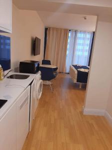 a kitchen with a sink and a living room at Orbi siti in Batumi