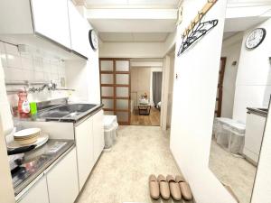 a kitchen with a sink and a counter at Shinjuku Waseda D1 in Tokyo