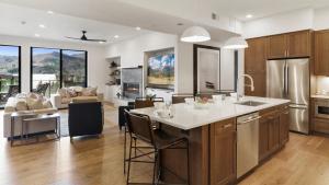 a kitchen and living room with a table and chairs at Chalet Breton in Steamboat Springs