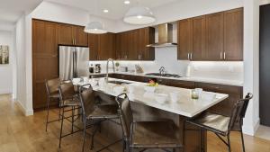 a kitchen with a large white table and chairs at Chalet Breton in Steamboat Springs +35 photos