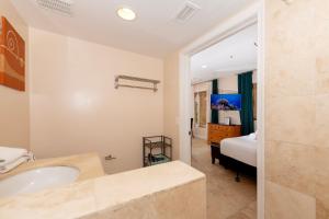 a bathroom with a tub and a bedroom with a bed at South Of Fifth Studio With Pool in Miami Beach +6 photos