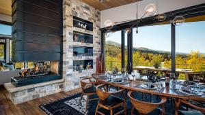 a dining room with a fireplace and a table and chairs at Chalet Cascada in Steamboat Springs