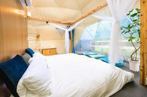 a bedroom with a bed in a tent at SPRINGS VILLAGE Ashigara Tanzawa Onsen Resort & Gl - Vacation STAY 41907v in Hata