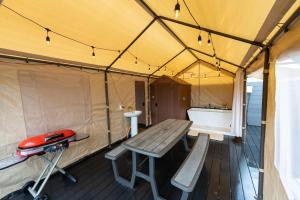 a tent with a bench and a table in it at SPRINGS VILLAGE Ashigara Tanzawa Onsen Resort & Gl - Vacation STAY 41912v in Hata
