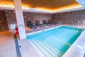 a swimming pool with chairs and a fire hydrant at HOM I 2D2B Piscina Jacuzzi Estacionamiento Privado in Puerto Varas
