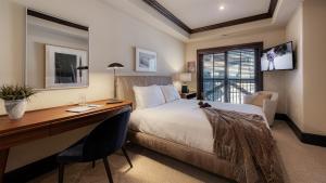 a hotel room with a bed and a desk and a desk at Chalet Crevasse in Vail +11 photos