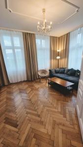a living room with a couch and a table at Villa Ohrenstein - Komfort Suite in Bad Ischl