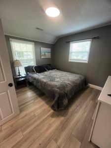 a bedroom with a bed in the corner of a room at Walk to Downtown | Workspace + Pet Friendly in Pleasanton