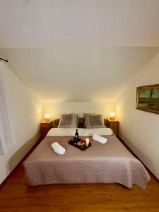 a bedroom with a large bed with two lamps at Głuszyńska Przystań in Stawiska