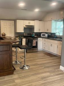 a kitchen with white cabinets and a table and chairs at Walk to Downtown | Workspace + Pet Friendly in Pleasanton +17 photos