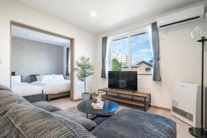 a living room with a couch and a bed at MKS202 - Vacation STAY 20135 in Gojōdōri