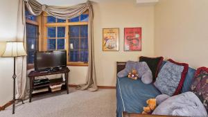 a living room with a couch with stuffed animals on it at Chalet Fairway in Beaver Creek