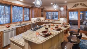 a kitchen with wooden cabinets and a large island at Chalet Fuego in Steamboat Springs