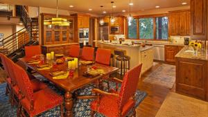 a kitchen with a wooden table and orange chairs at Chalet Fuego in Steamboat Springs