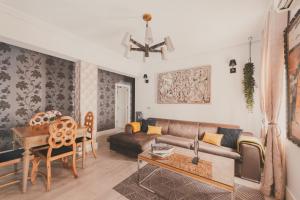 a living room with a couch and a table at City Deluxe Apartment in Madrid