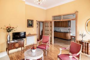 a living room with two chairs and a table at Cosmo - Old Money Apartment in Gdańsk +13 photos