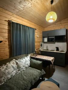 a living room with a couch and a table at Meidan Oda Holiday Homes in K'obulet'i