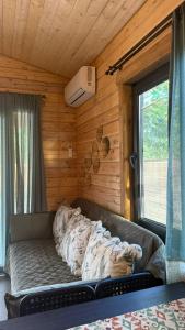 a couch in the corner of a room with a window at Meidan Oda Holiday Homes in K'obulet'i +88 photos