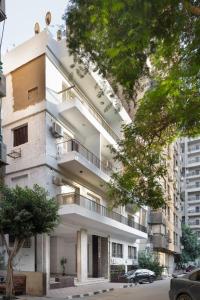 Un edificio de apartamentos con balcones en una calle de la ciudad. en The Boho Escape, en El Cairo