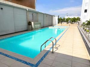 a swimming pool on the side of a building at Central Suite in Cúcuta